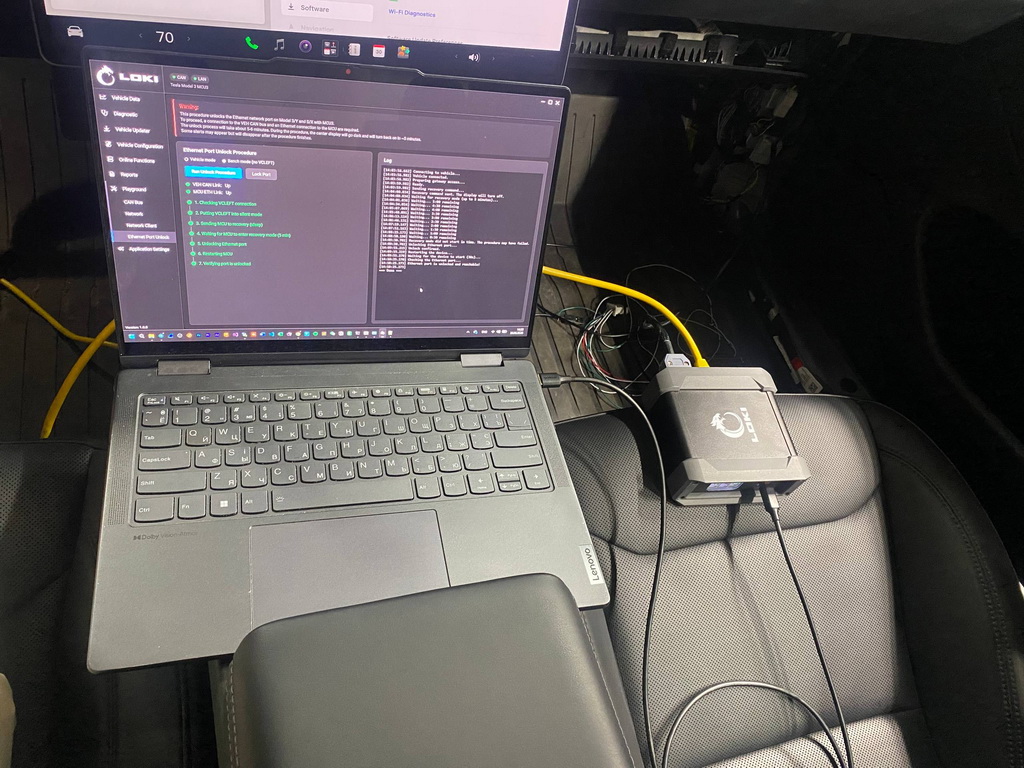 Diagnosing a Tesla vehicle using the LOKI PRO scanner in an automotive workshop